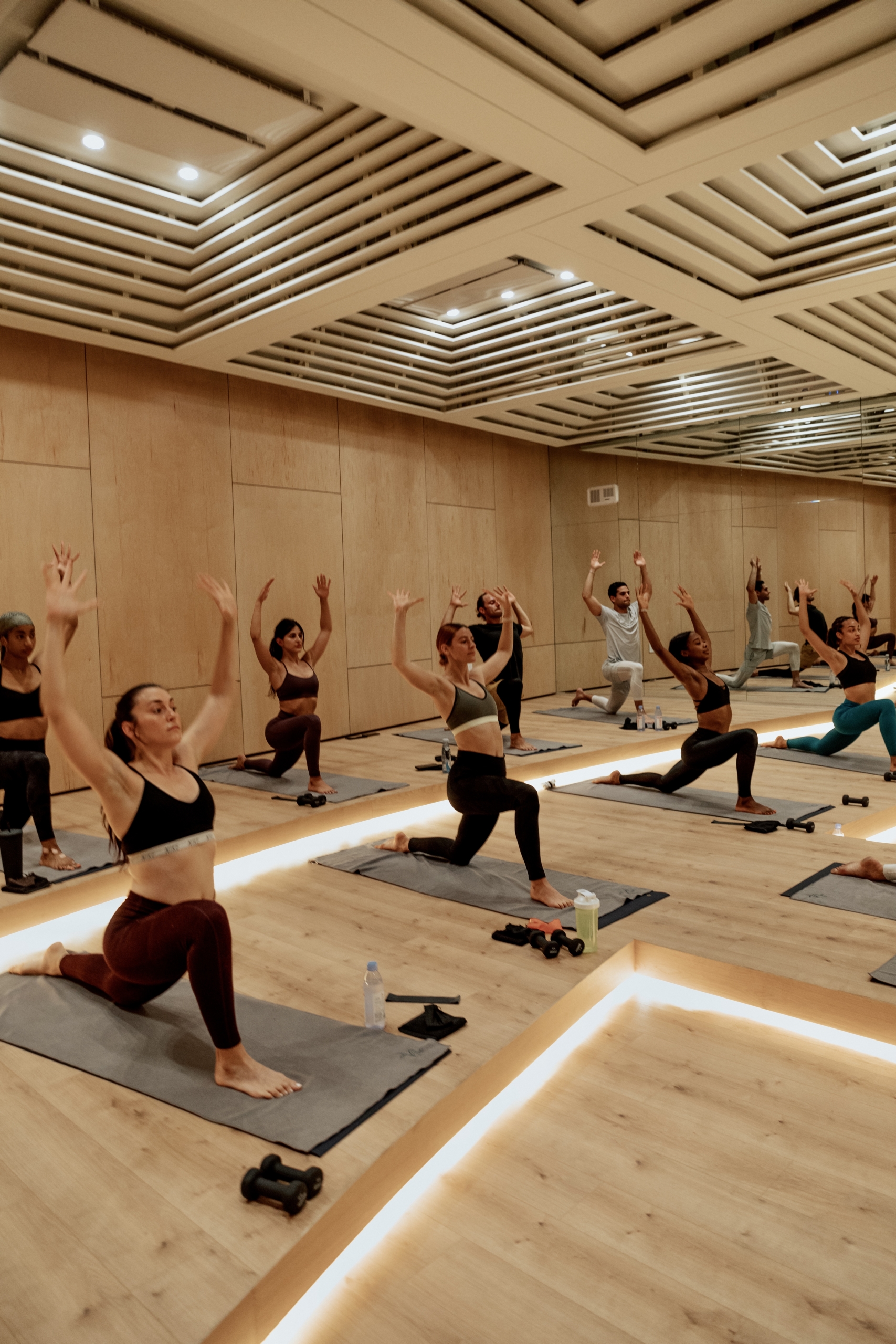 An image of several people doing a yoga pose during a class at the Heated Room.
