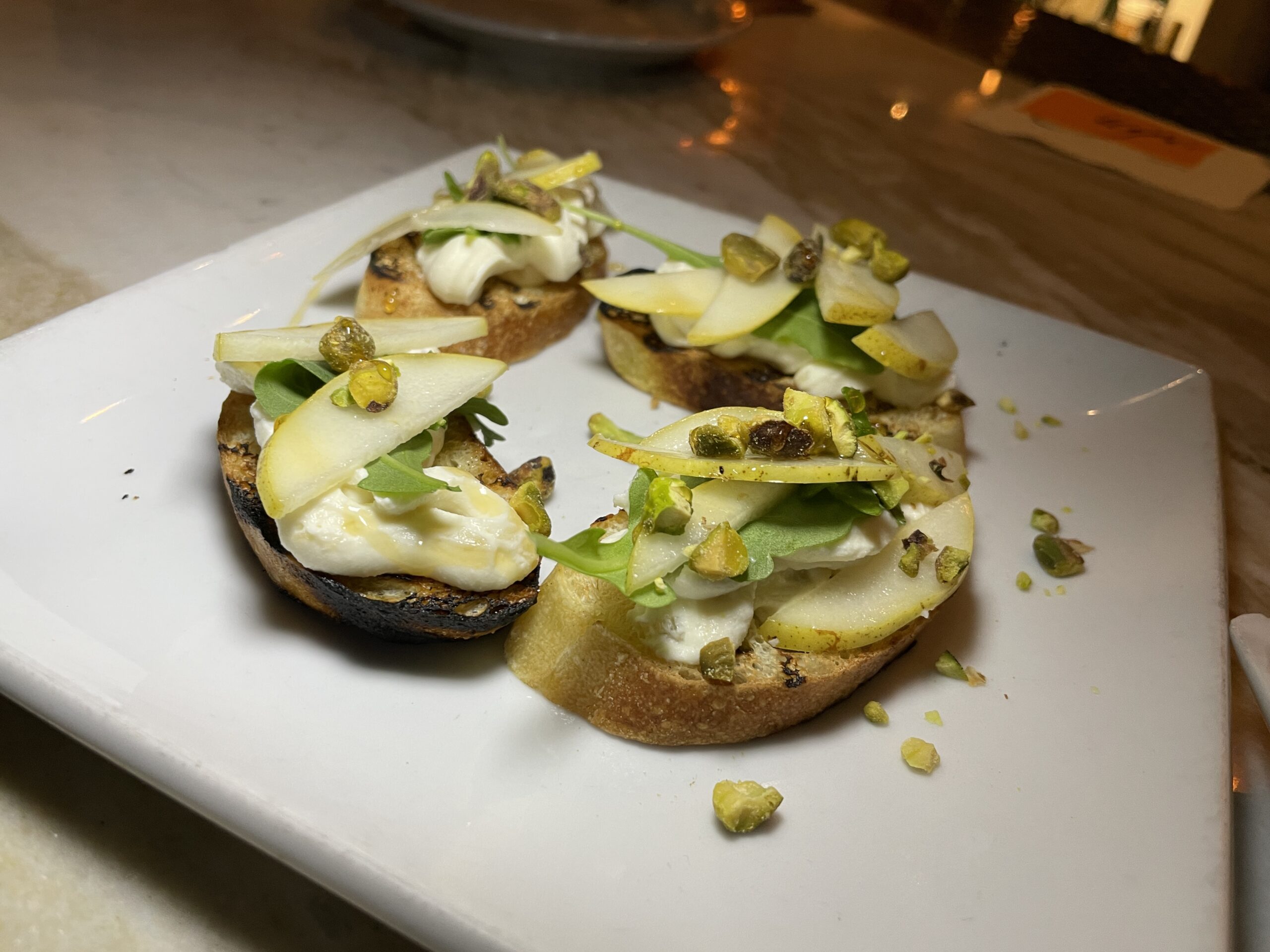 The Lounge at Ugo's menu offers Italian dishes composed of fresh and homemade flavorful ingredients. I recommend starting with appetizers such as the Ricotta Crostini (crostini spread with whipped ricotta, pear slice, and pistachios).