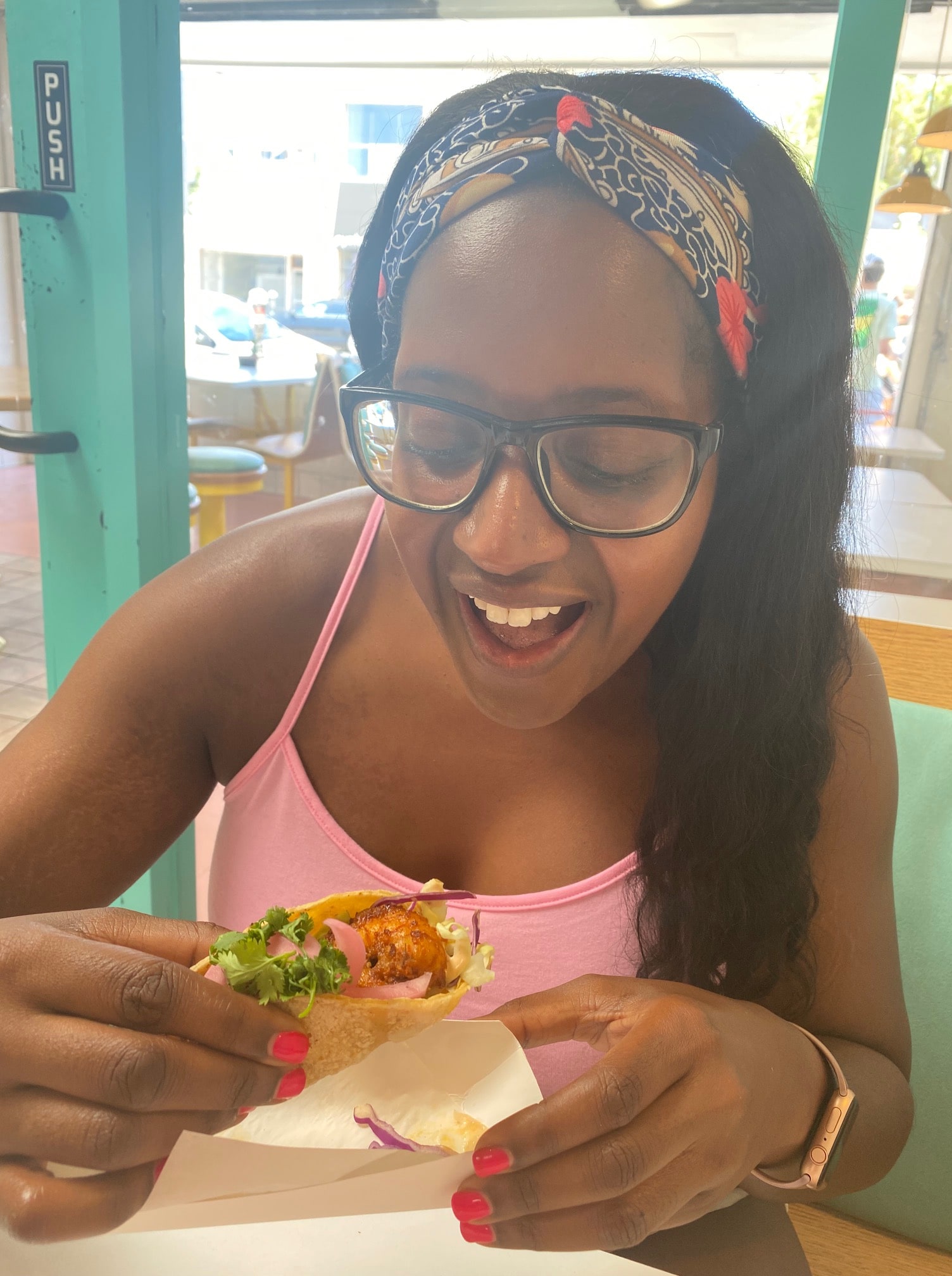 Ariel takes a bite from the mouthwatering Crispy Shrimp Chicas Taco.