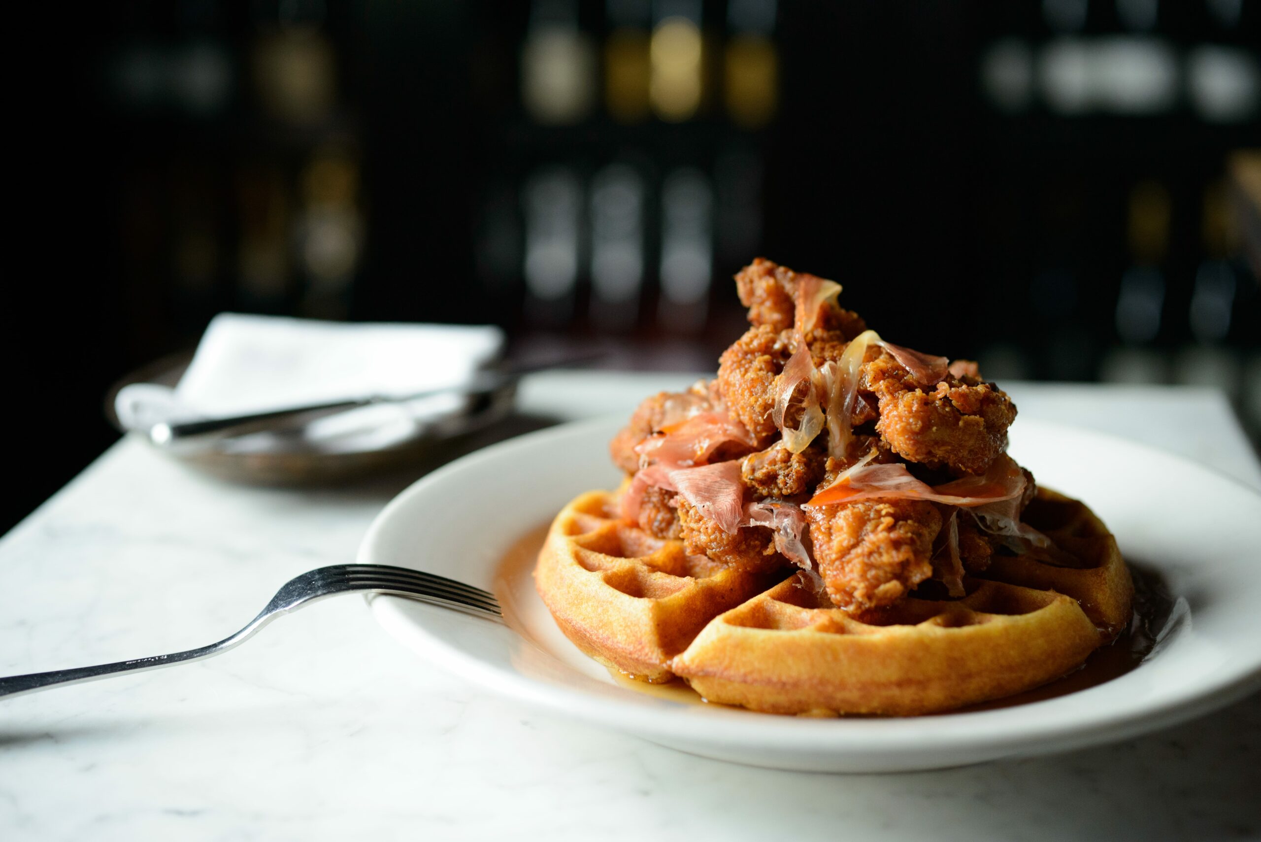 An image of the Spanish Fried Chicken & Cornmeal Waffle with Chile-Cumin Butter from A.O.C.