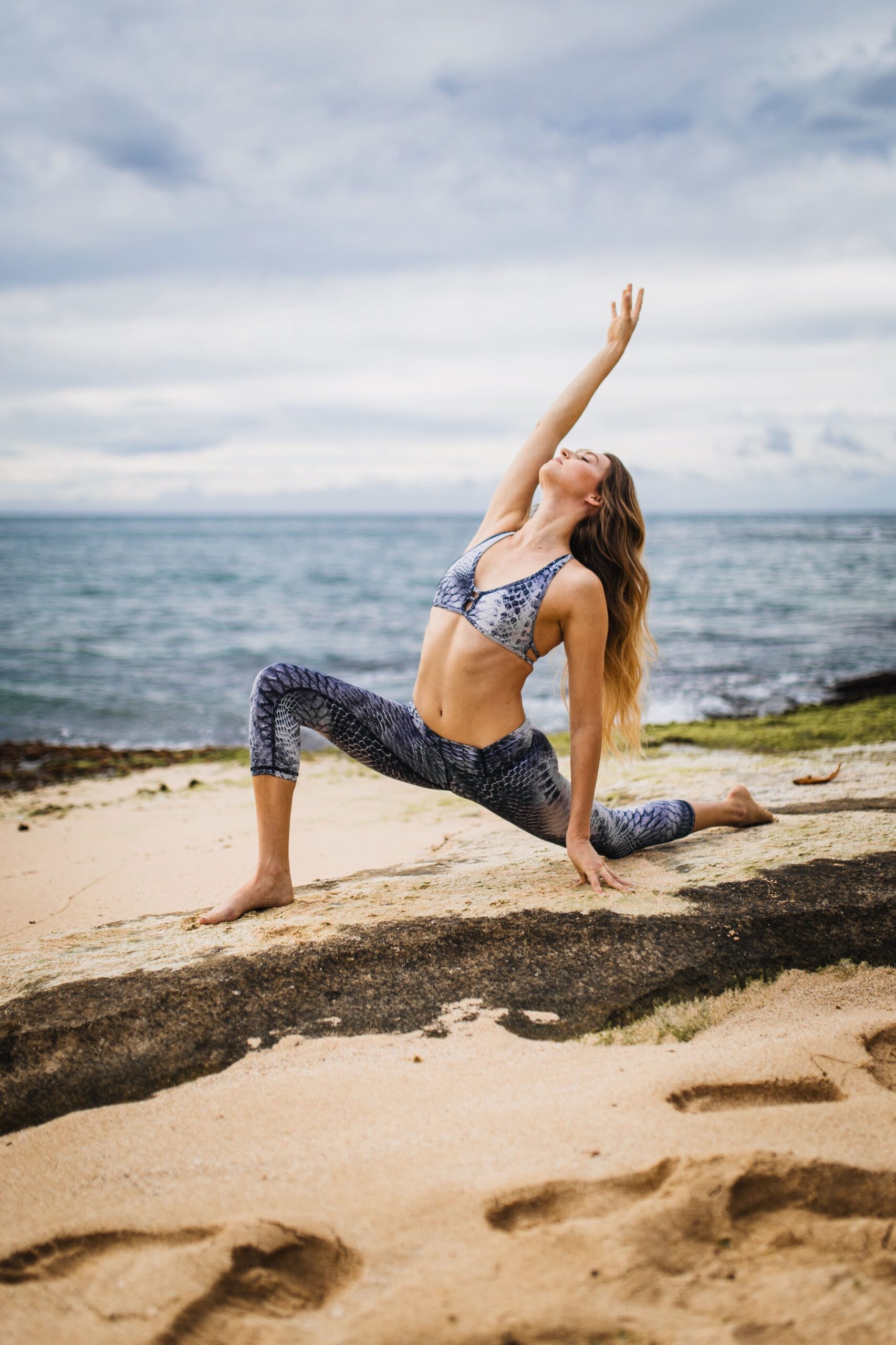 Anti-aging tip about yoga. A photo of a woman on the beach doing a yoga pose.