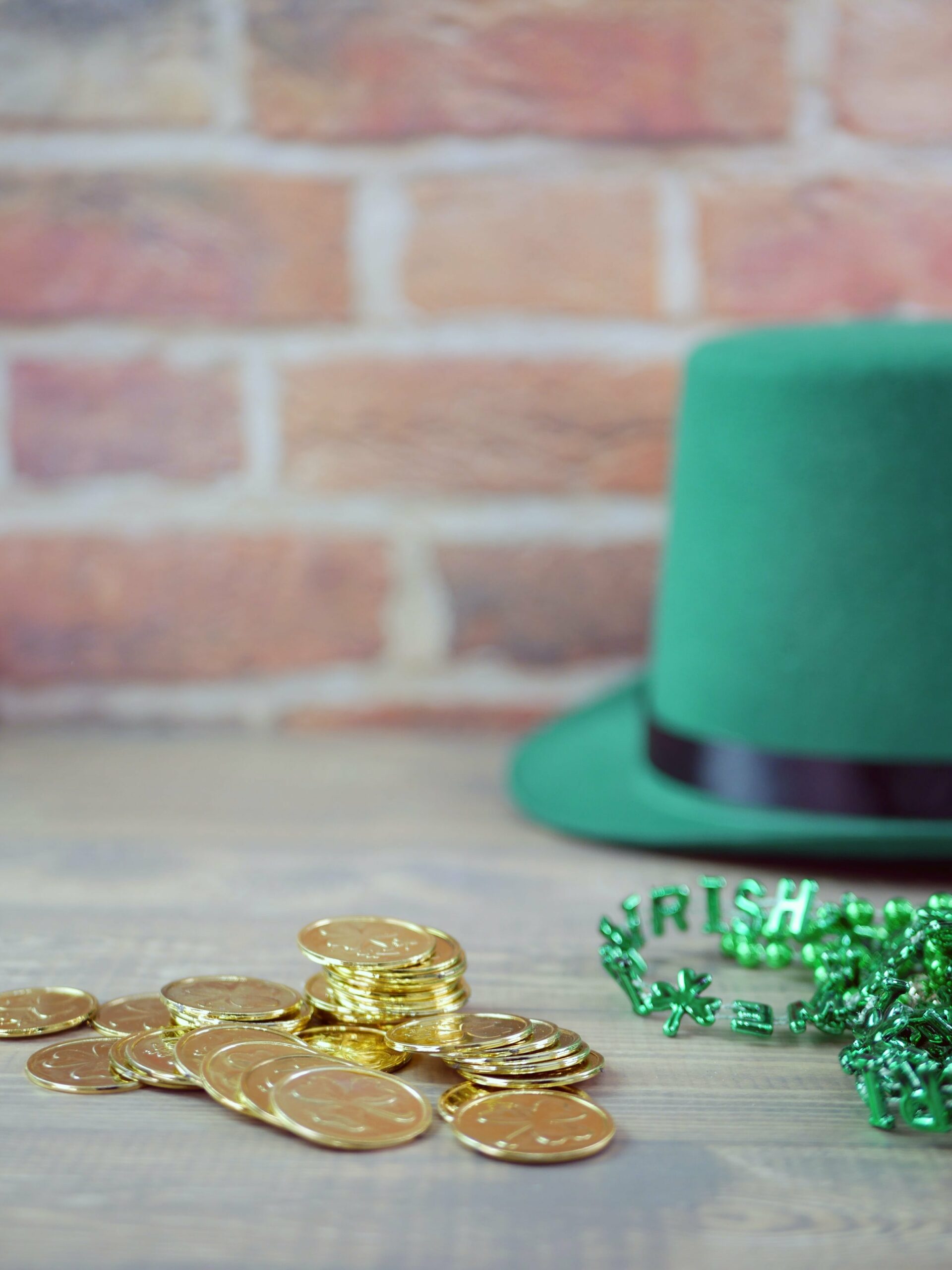 A photo of a green hat, green beads and coins to celebrate St. Patrick's Day