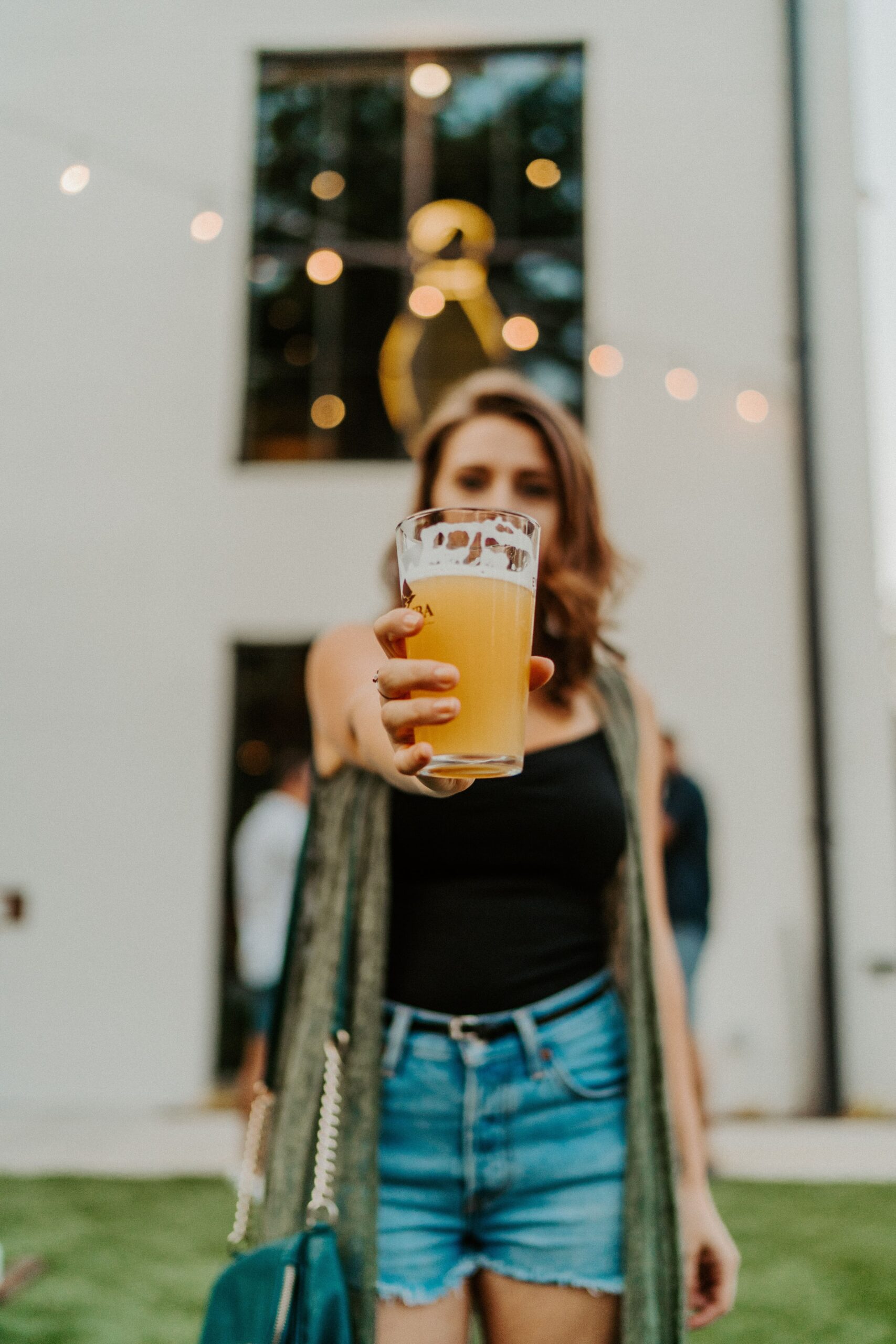 An image of a woman holding a pint of beer.