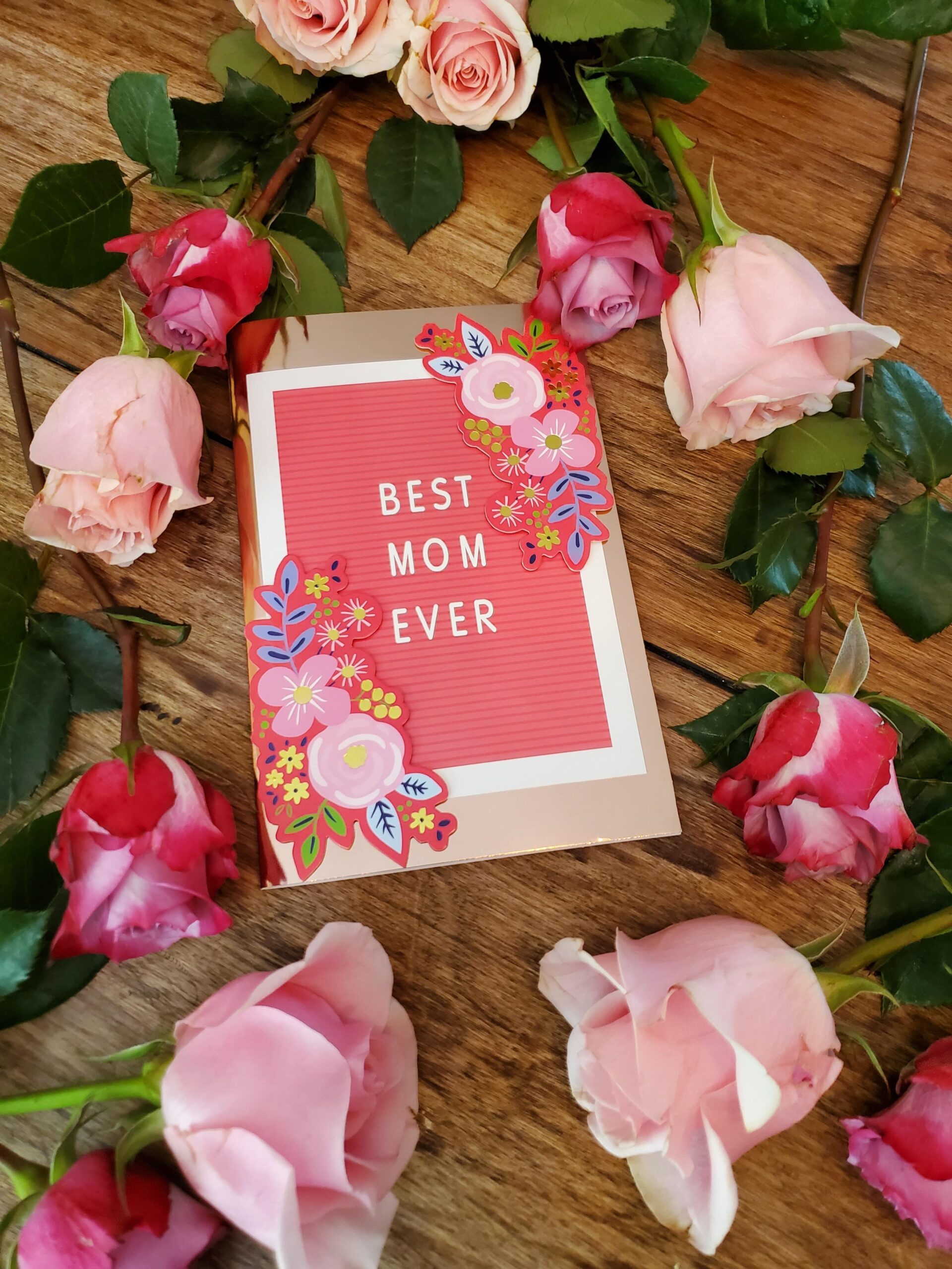 An image of a Mother's Day card surrounded by roses that says, Best Mom Ever.