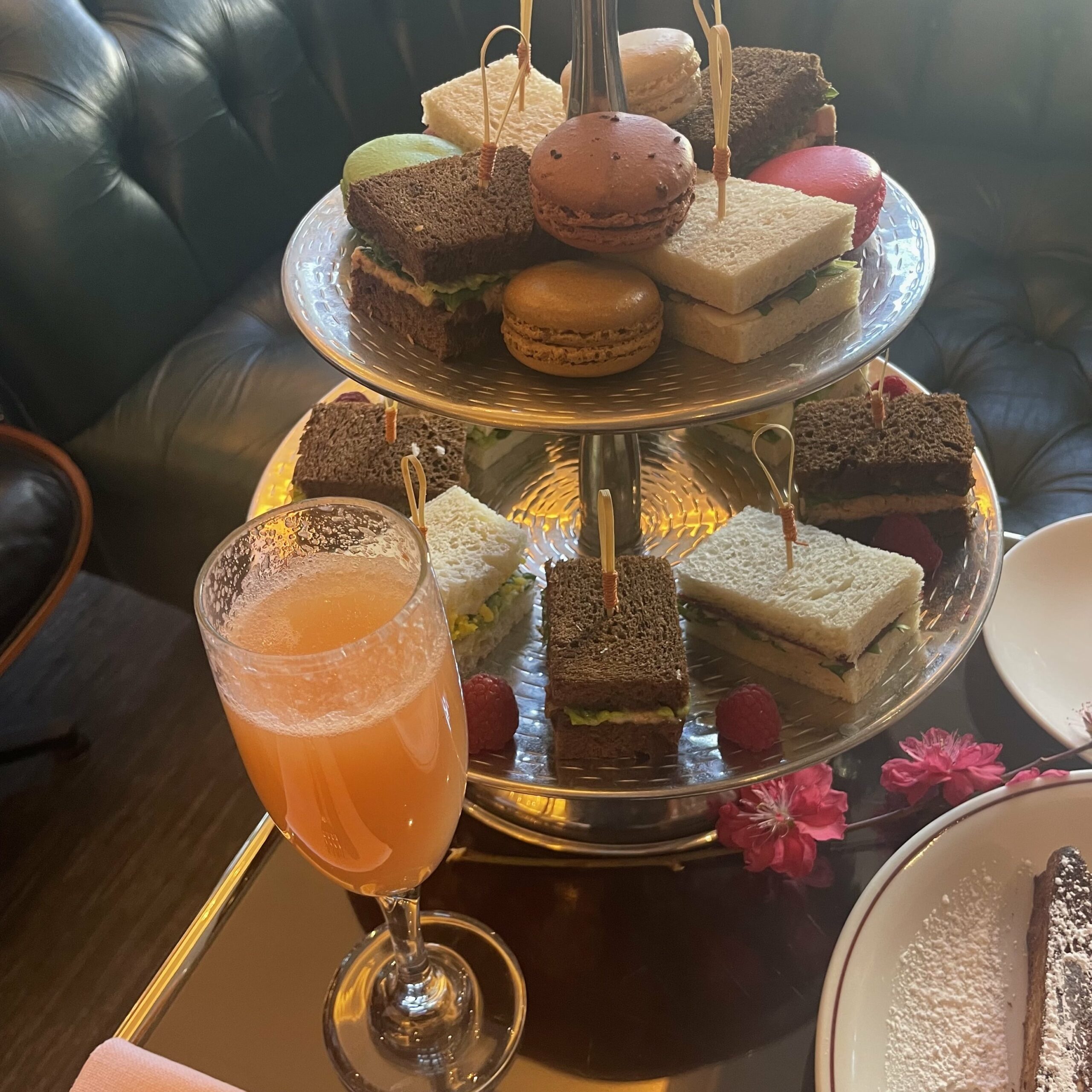 An image of a Bellini , macaroons, and mini sandwiches served at the Mr. C Bellini Brunch.
