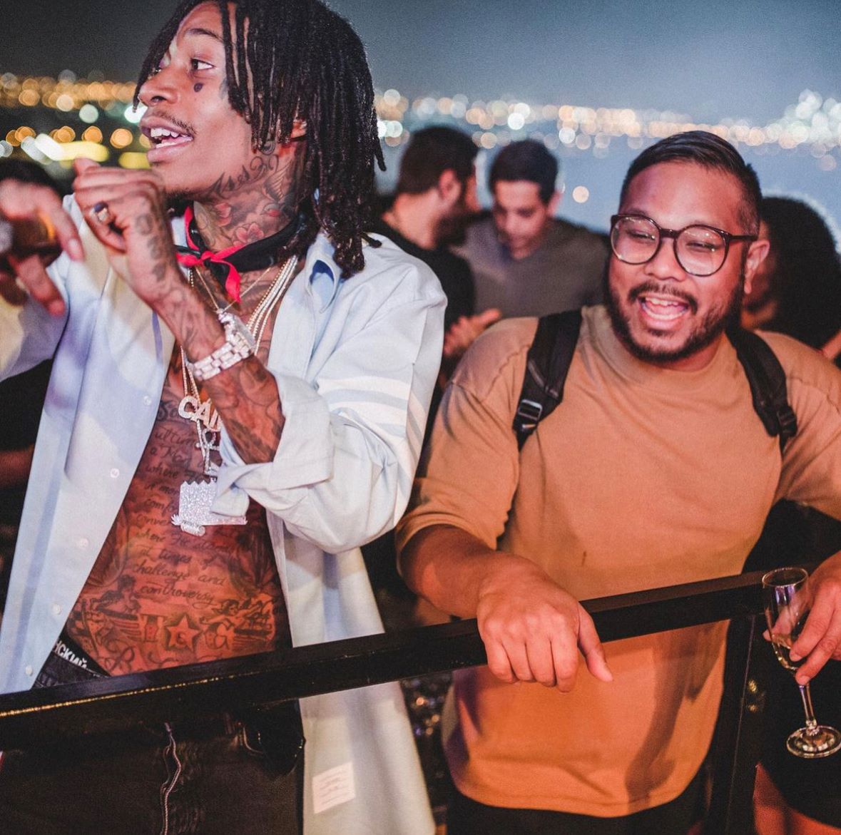 An image of Wiz Khalifa and his DJ, DJ Bonics partying after a concert.