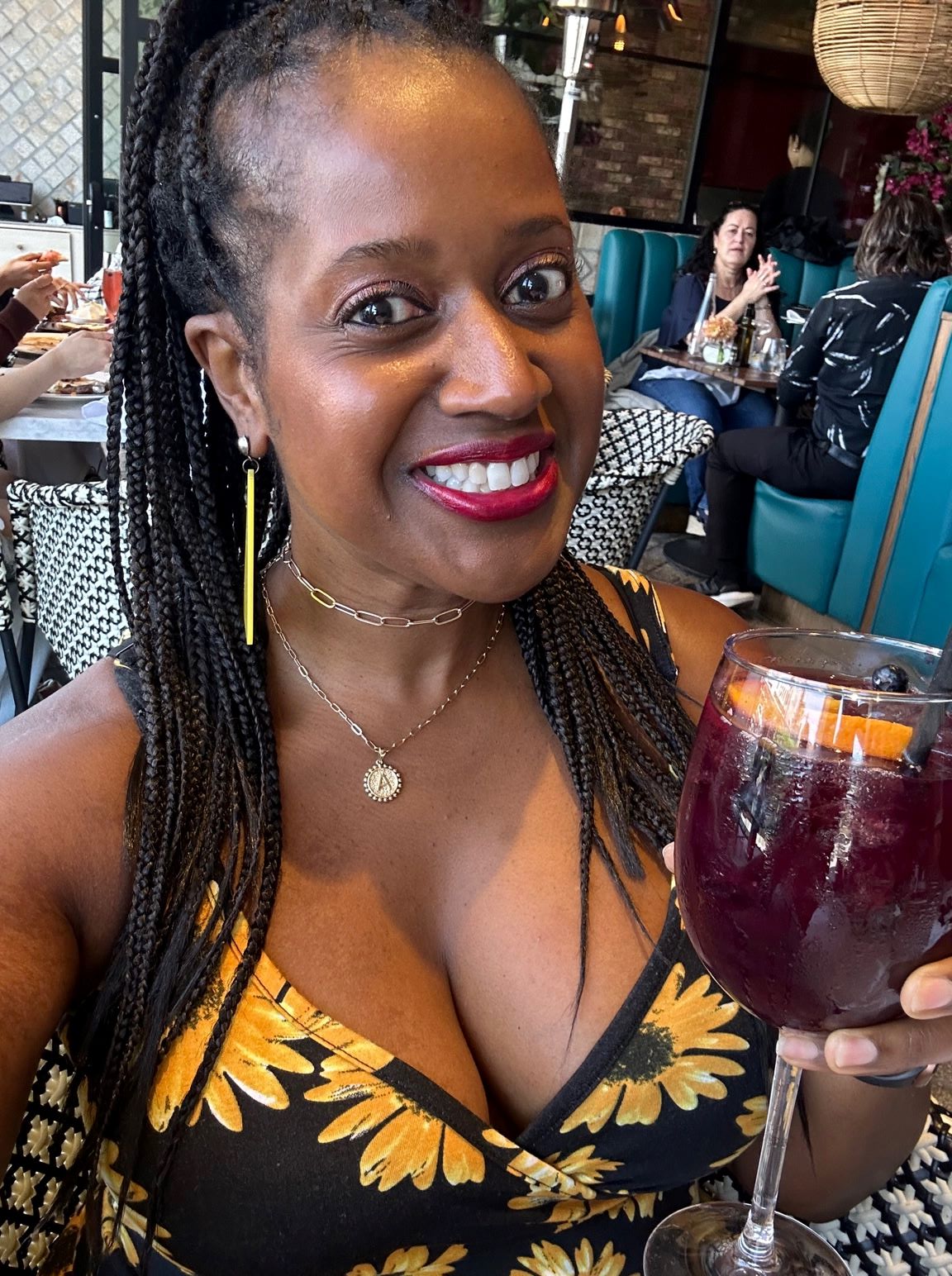 An image of Ariel holding a glass of sangria.