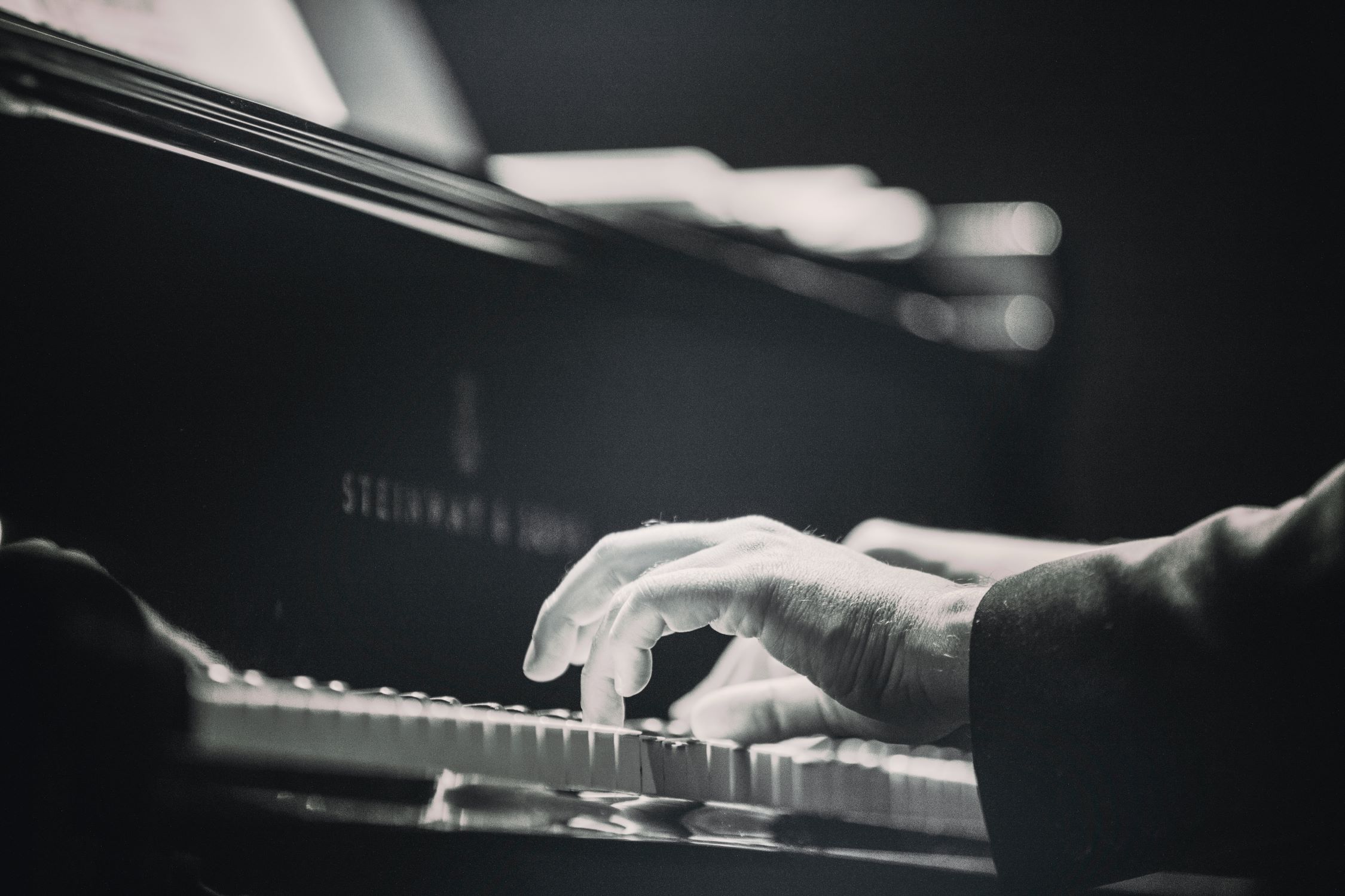 An image of hands playing the piano.