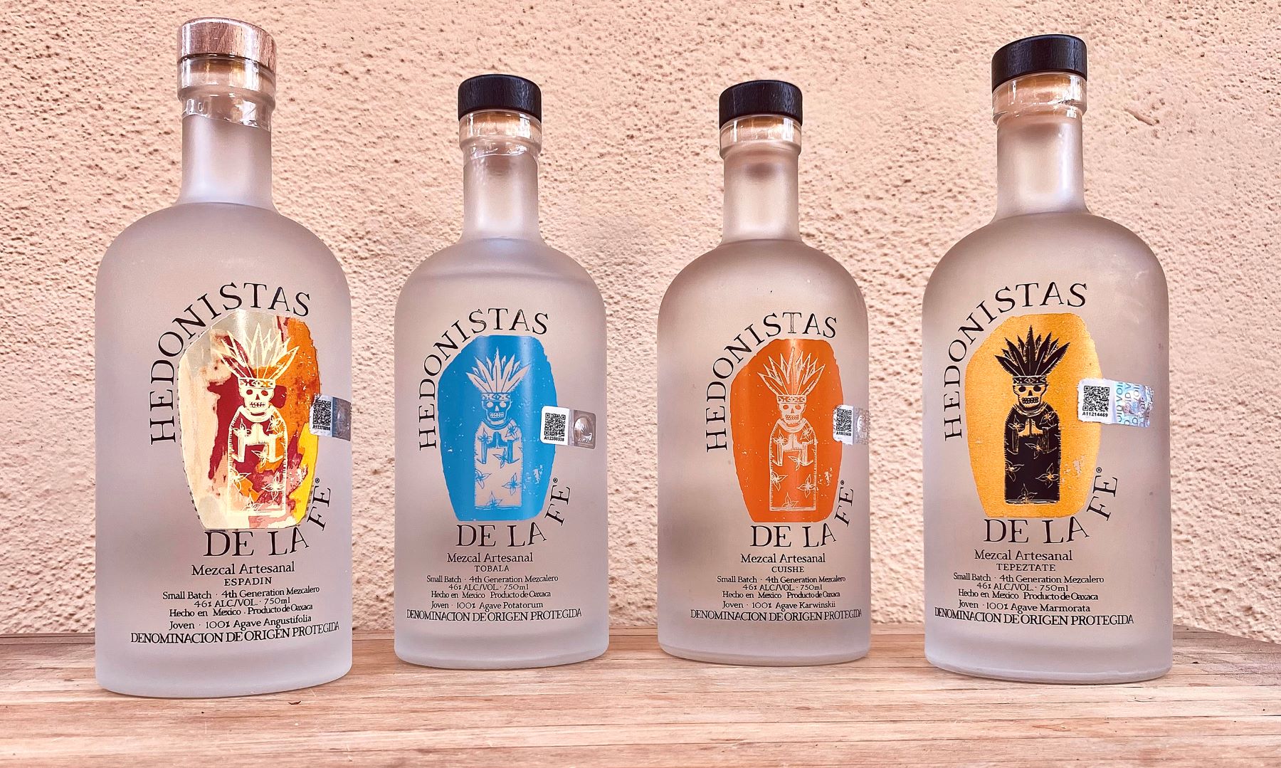 An image of four bottles of Hedonistas de la Fe Mezcal