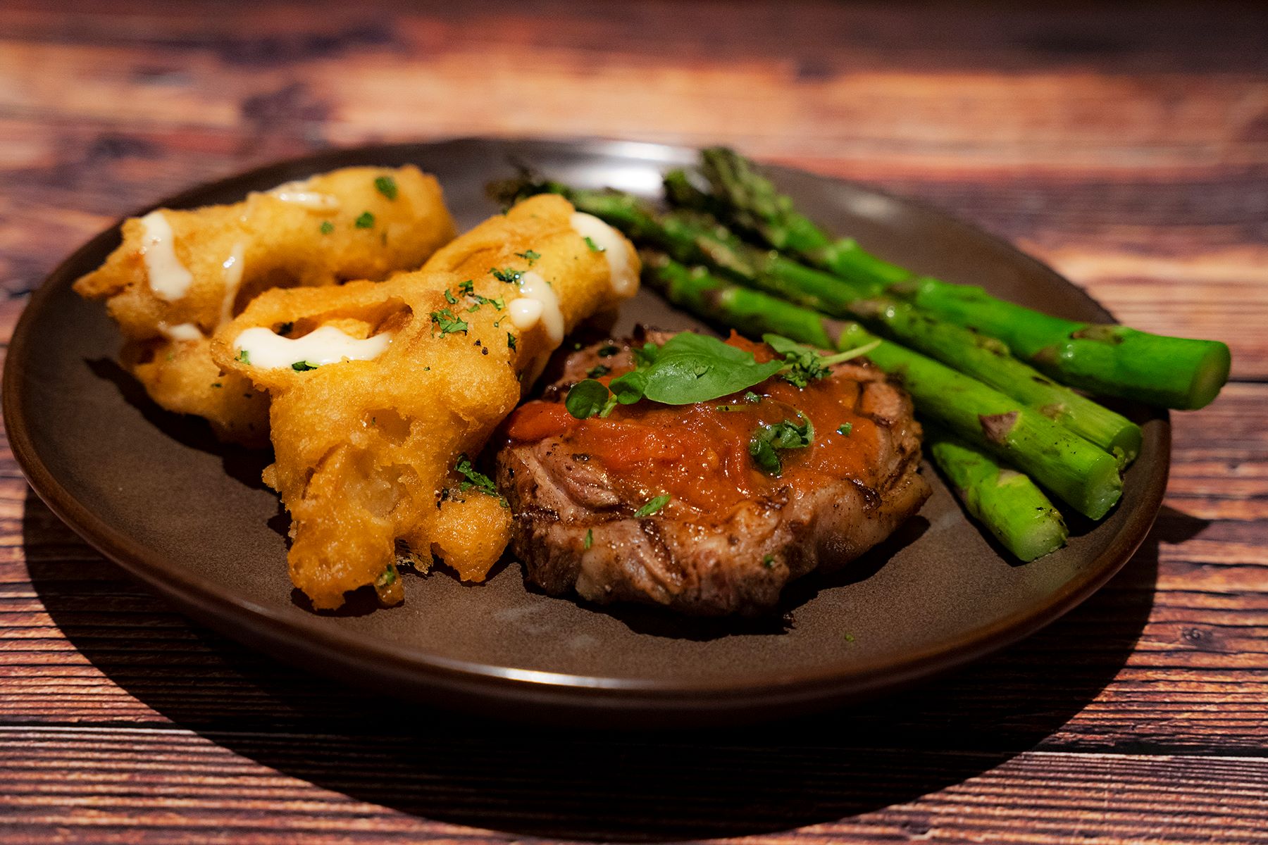 An image of Black Angus' Samuel Adams Summer Ale New York Strip complete with beer-battered potato wedges and grilled asparagus
