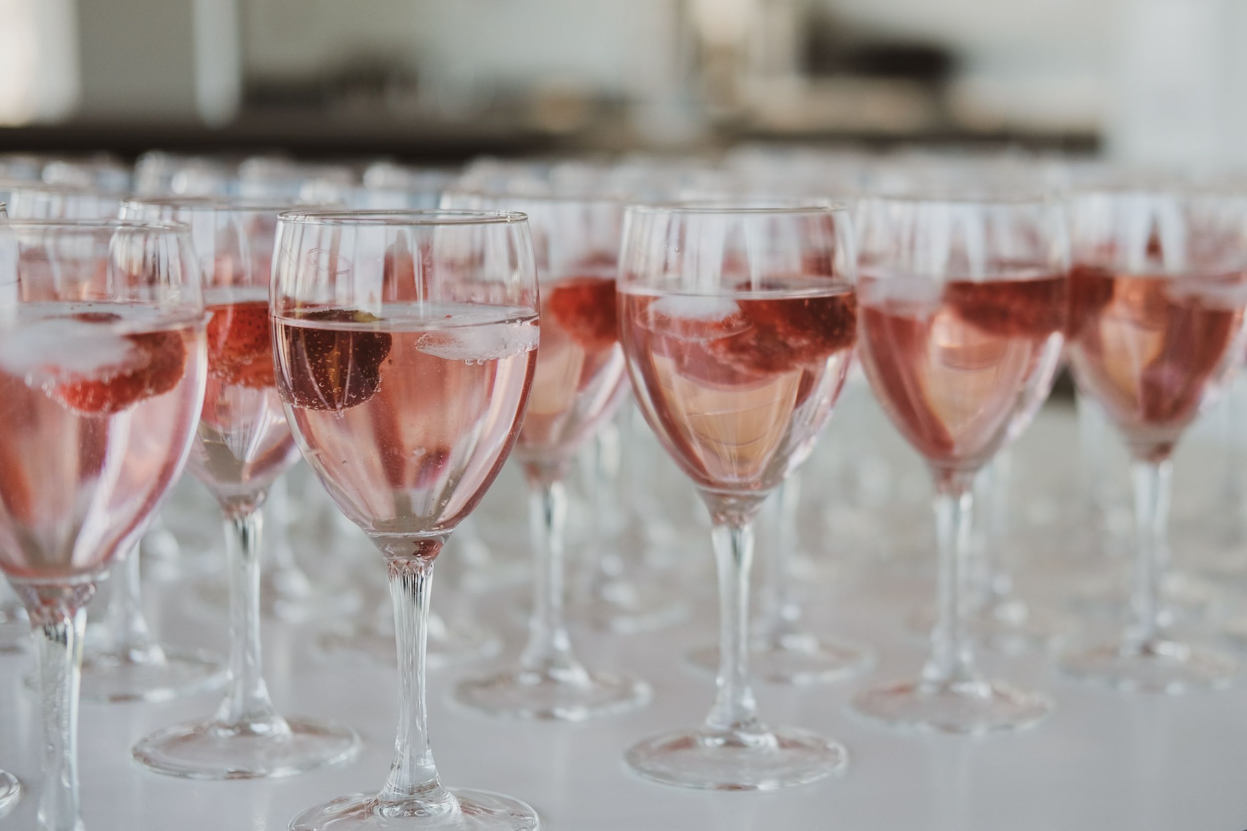 An image of numerous glasses of rosé wine.