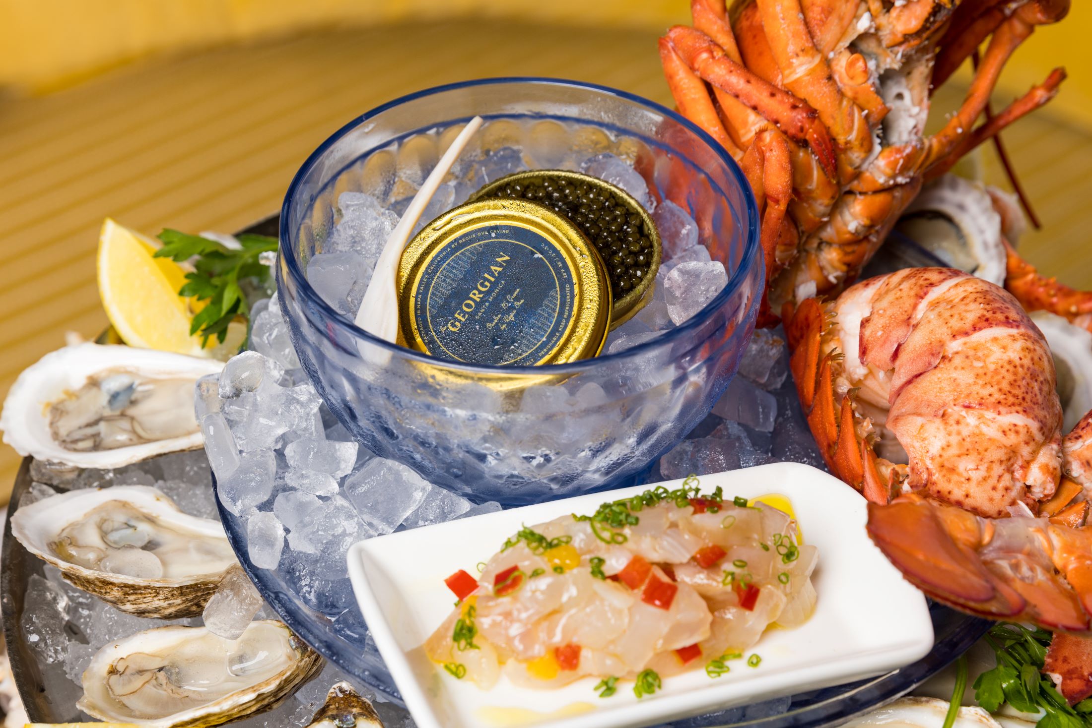 An image of caviar surrounded by oysters and lobster.