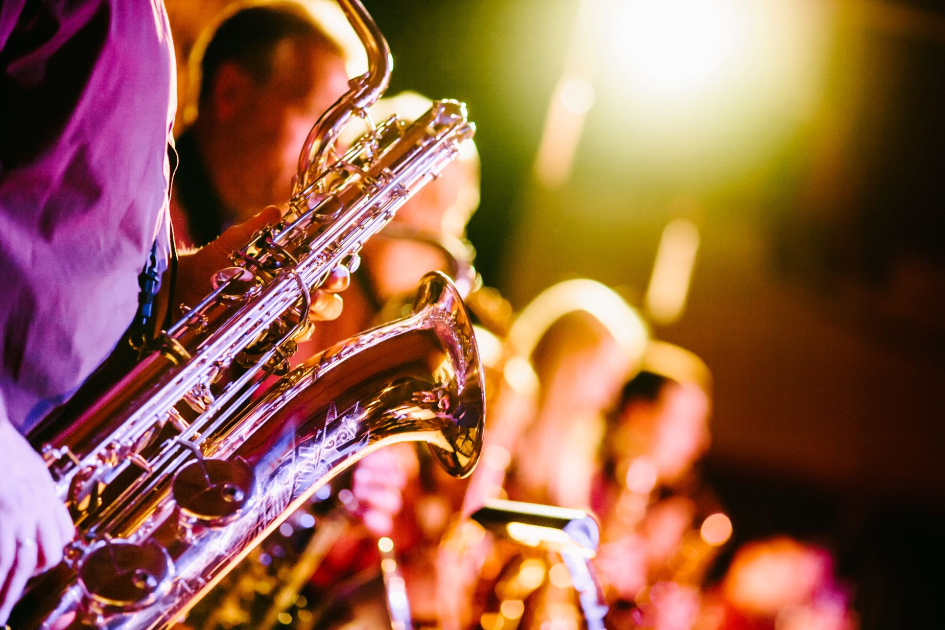 An image of a jazz band with a saxophone in the forefront. 