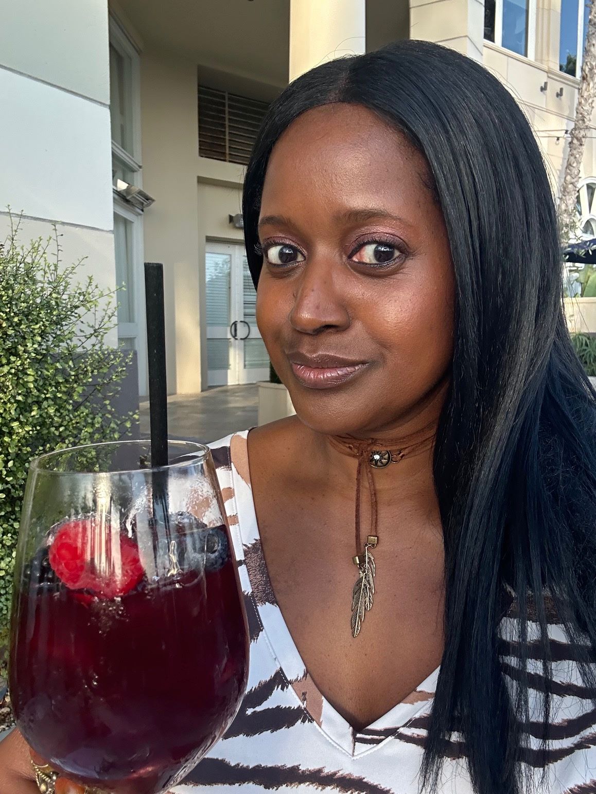 An image of Ariel holding a glass of Red Sangria.