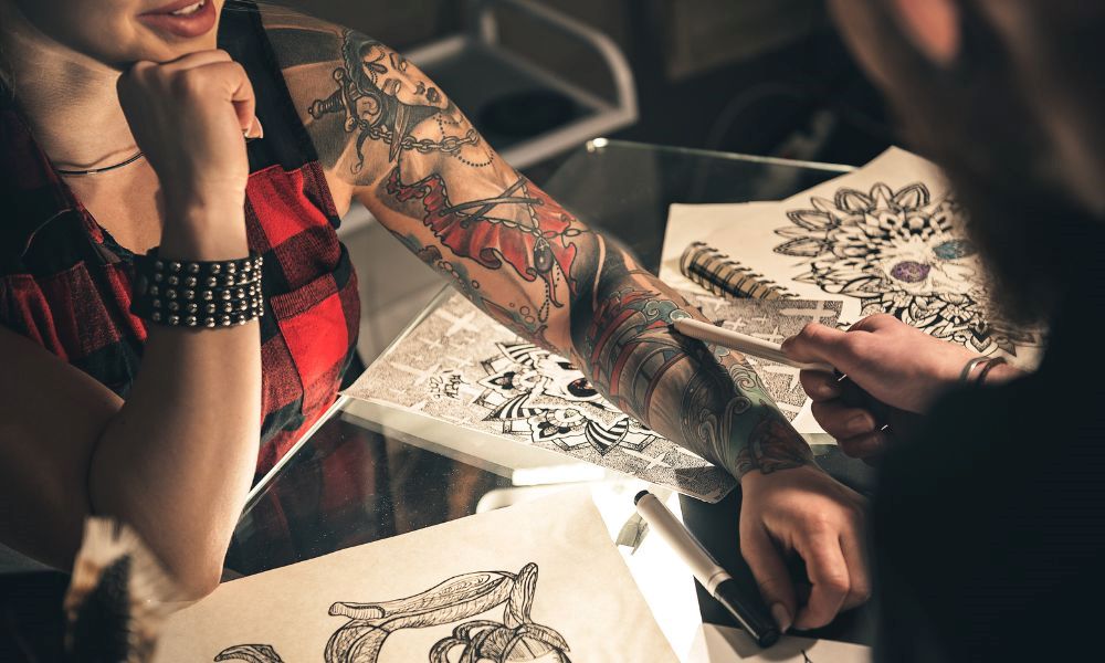 An image of a person with a sleeve tattoo getting a consultation.