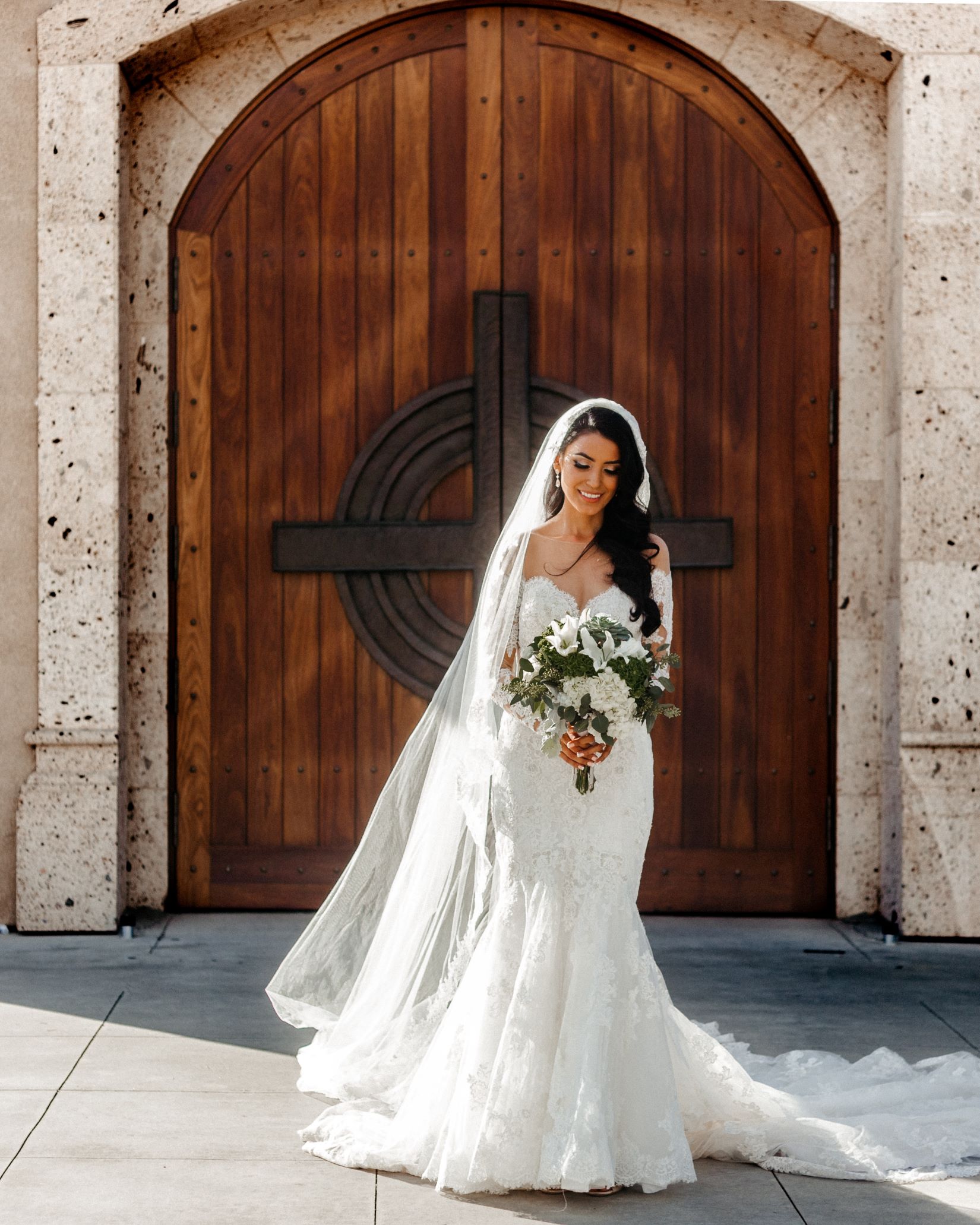 An image of a bride standing outside a church.