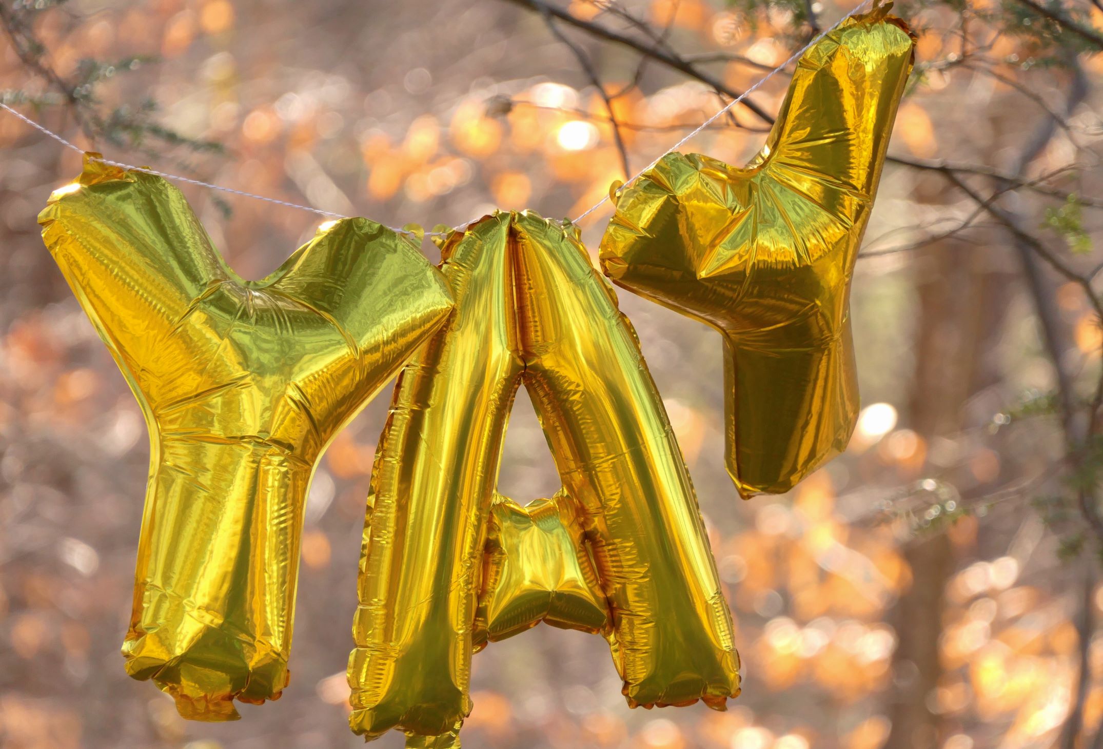An image of golden balloons spelling out the word, 'Yay.'