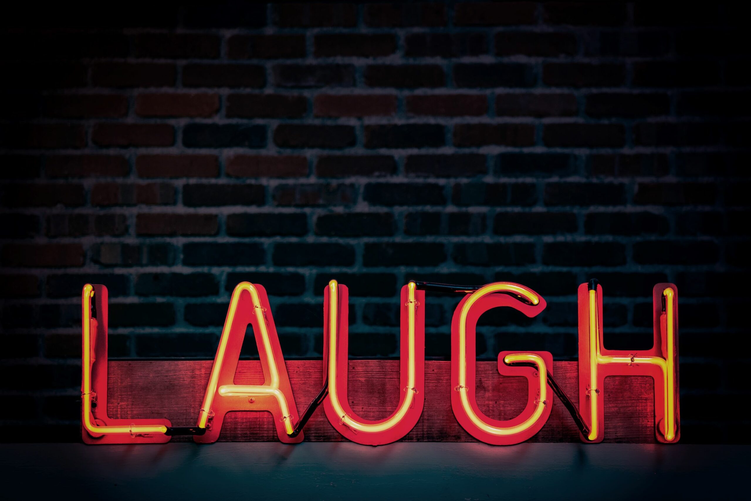 An image of a sign with the word 'laugh'