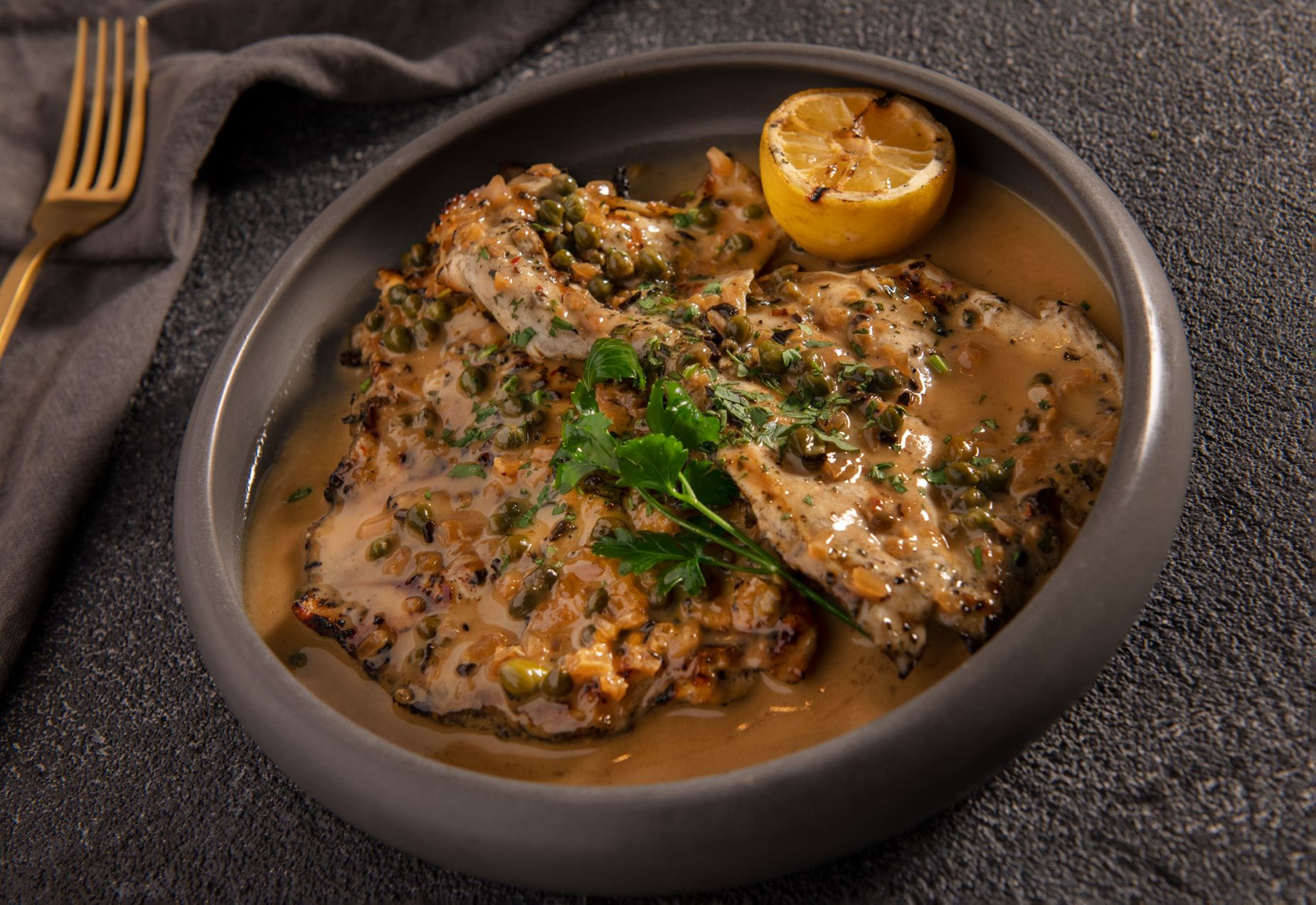 An image of the Chicken Paillard (black garlic & Caper beurre blanc) from Sparrow Italia at Hotel Figueroa. 