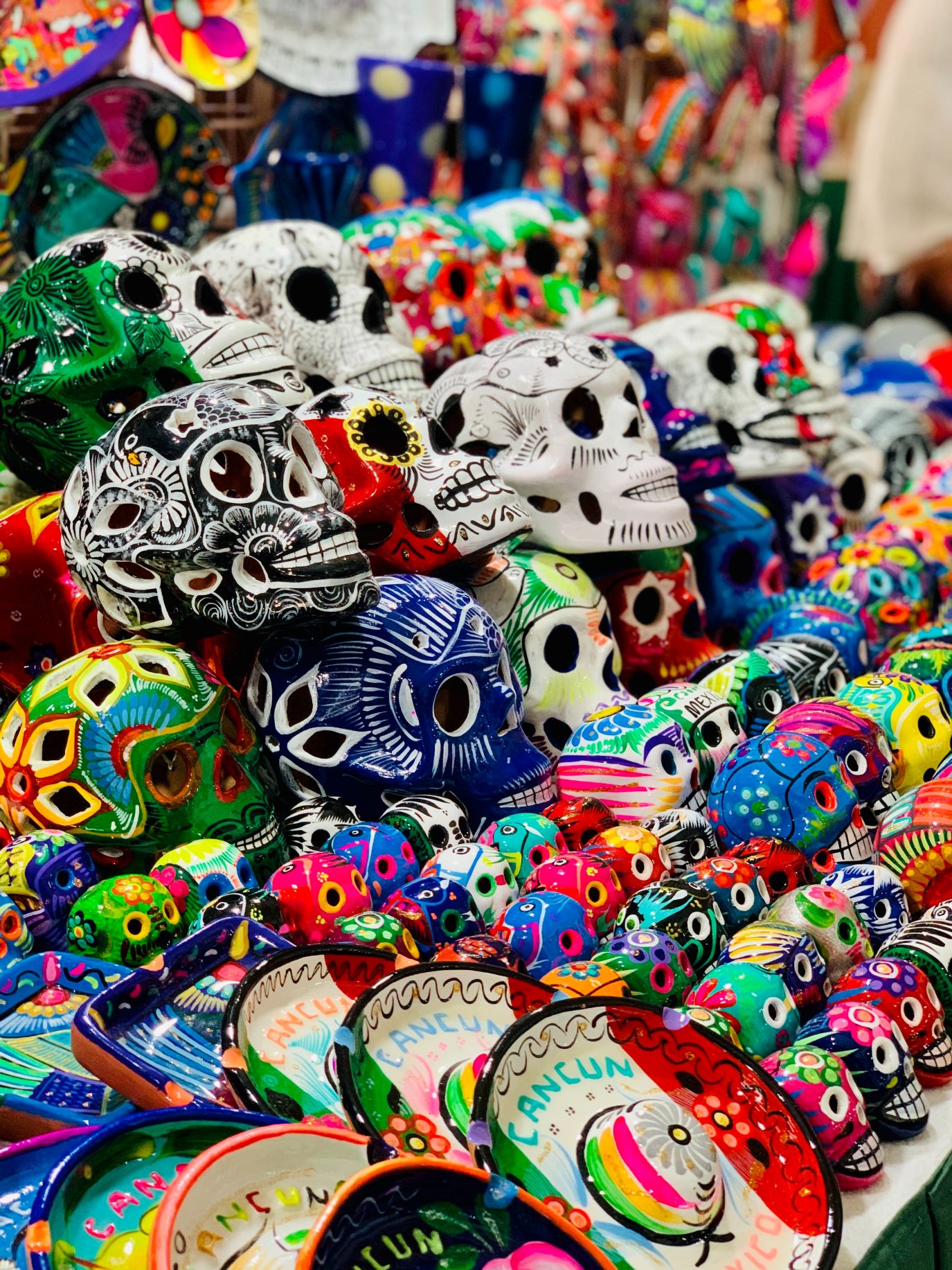 An image of painted skulls representing the Dia de los Muertos celebration.;