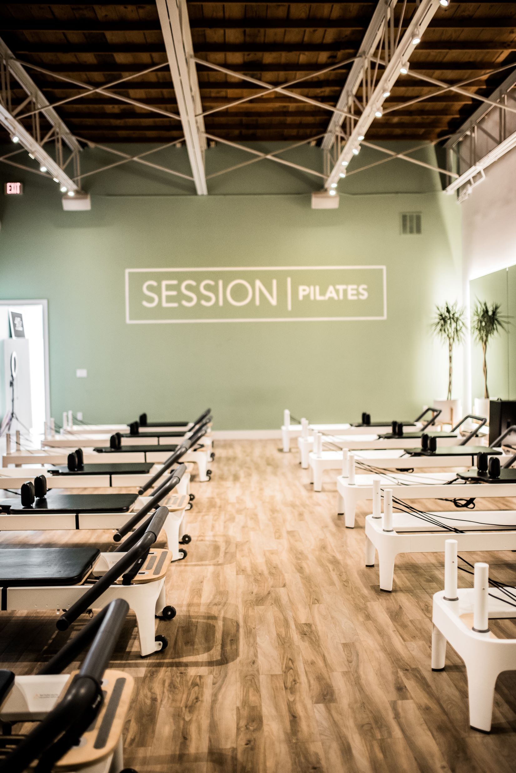 An image of a Pilates studio with reformers. 