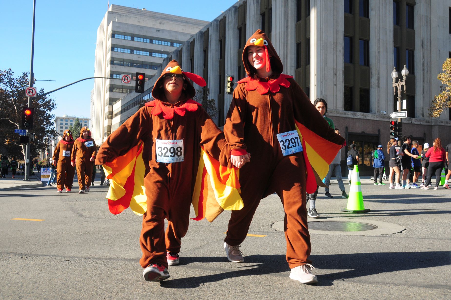 An image of two people dressed in costume at the turkey trot for a happy Turkey day.