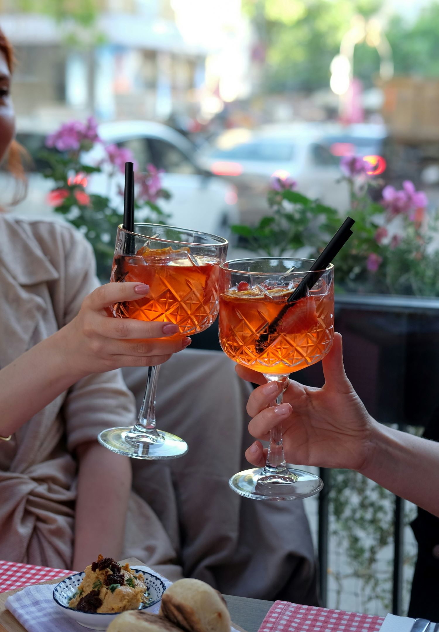 An image of two people holding cocktails.