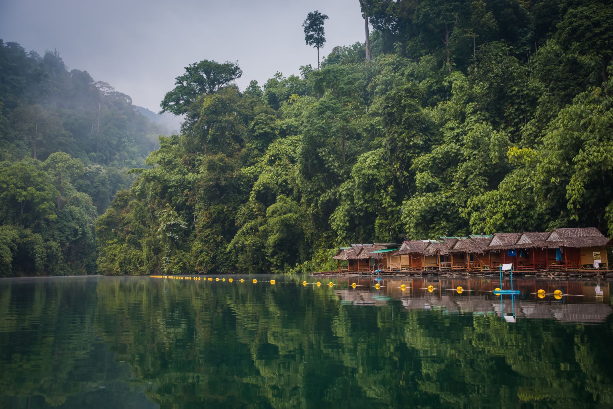 An image of Thailand - a lake and alot of trees.