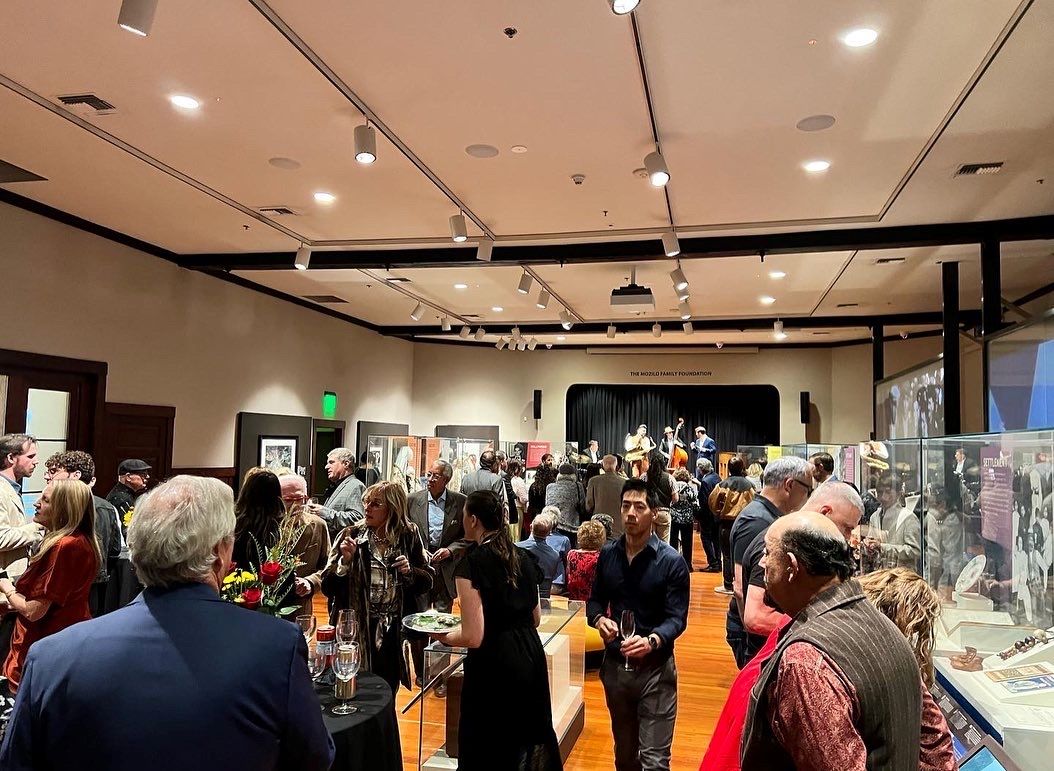 An image of attendees as the opening reception of the Louis Prima: Rediscovering a Musical Icon art exhibit at the IAMLA.