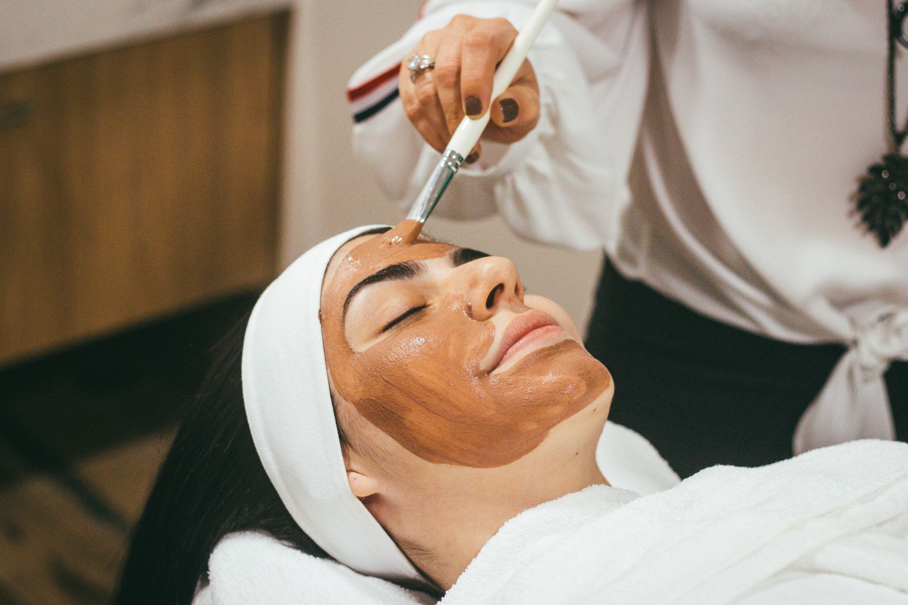 An image of a woman getting a facial.