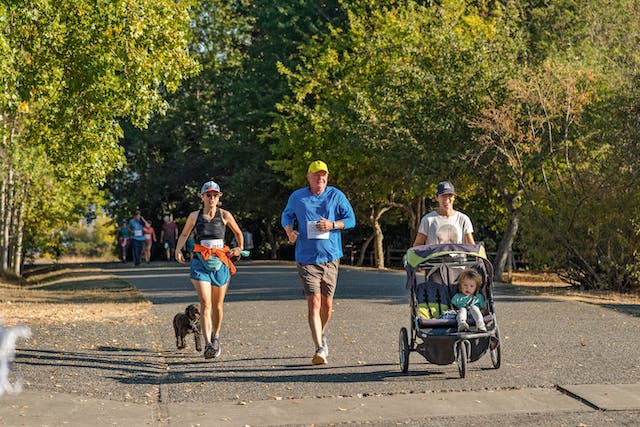 An image of people running and one is running with a baby stroller. 