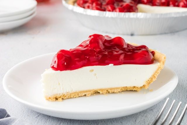 An image of a piece of cherry cheesecake.