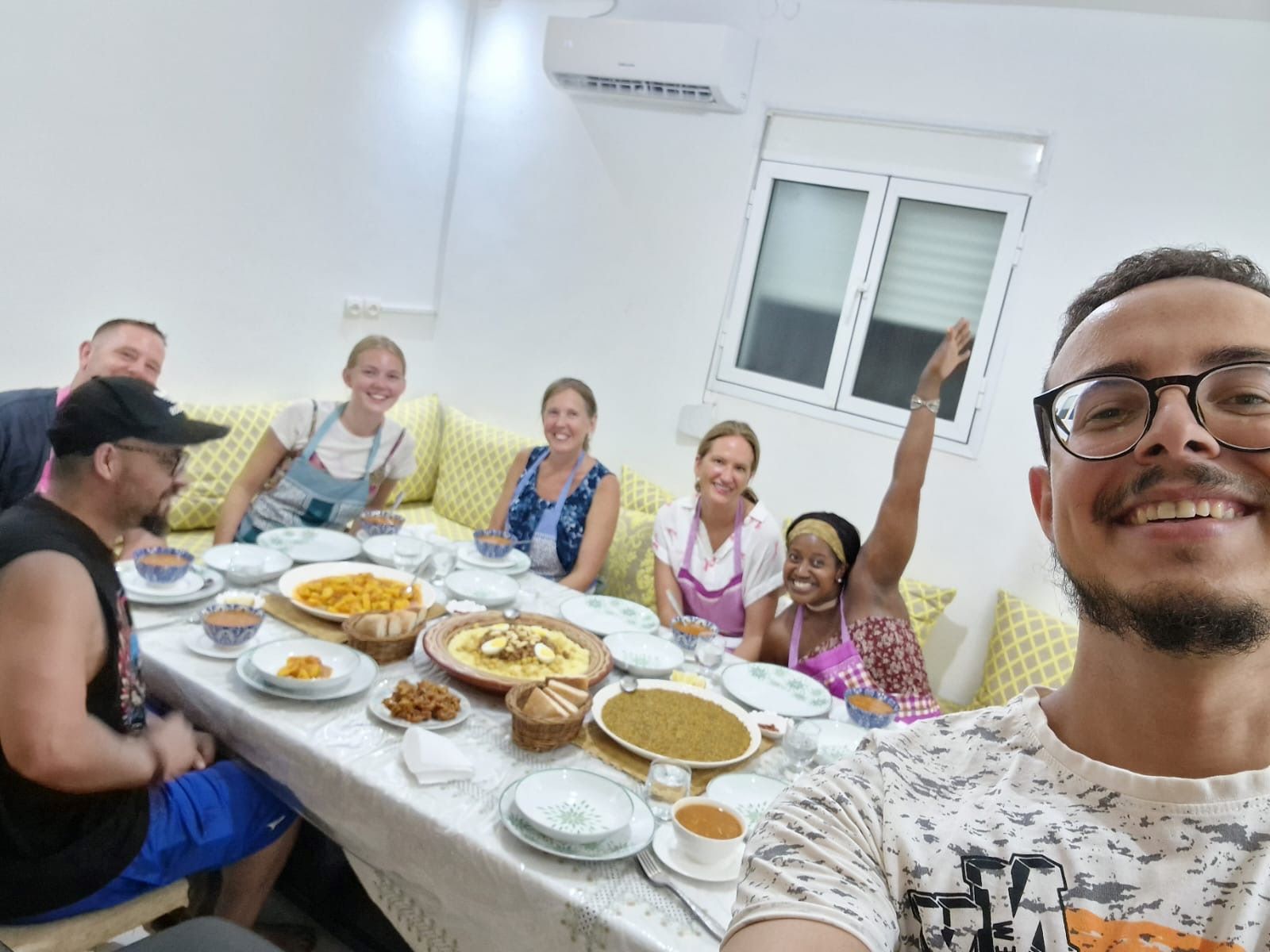 An image of a group of people about to  eat the food they cooked at their immersive Moroccan cooking class.
