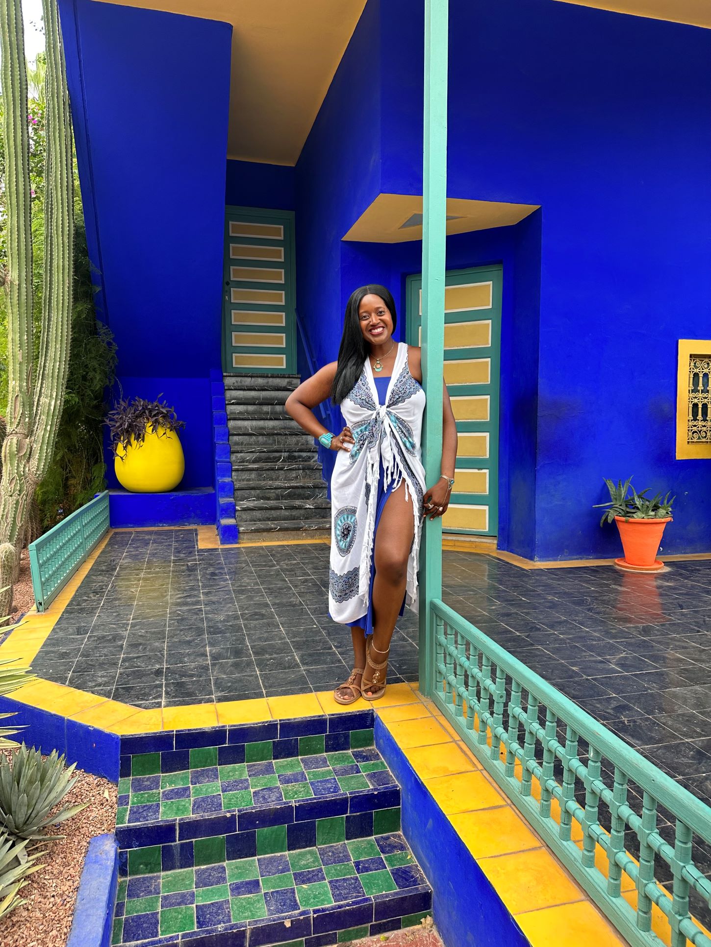 An image of a woman standing in the gardens of Jardin Majorelle in Marrakech.