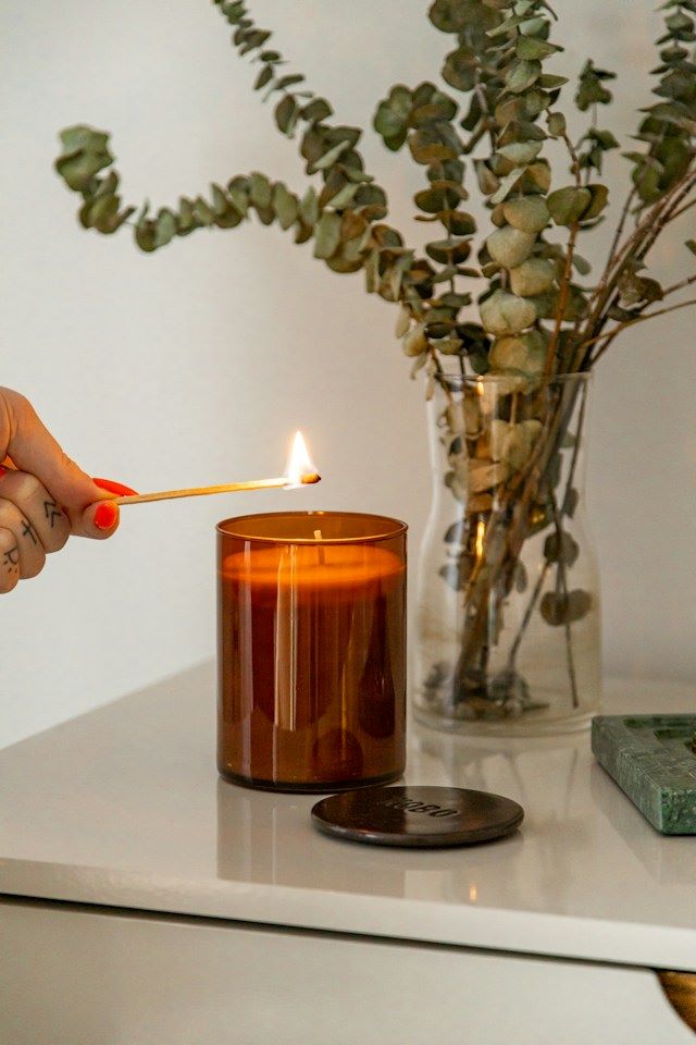 An image of someone lighting a candle
