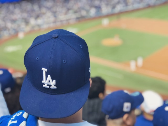 An image of someone wearing a Dodgers baseball hat at a Dodgers game.