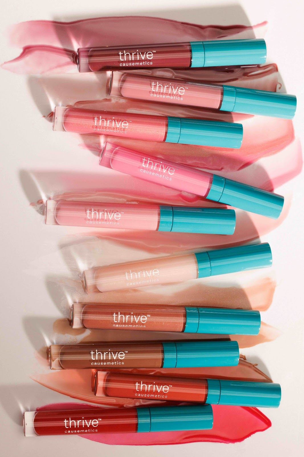 An image of the 10 Thrive Causemetics Sheer Strength Lip-Plumping Peptide Glosses.
