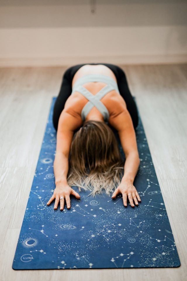 An image of a woman on a yoga mat.