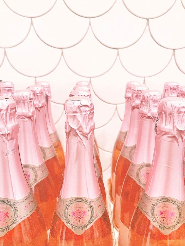 An image of several bottles of pink champagne.