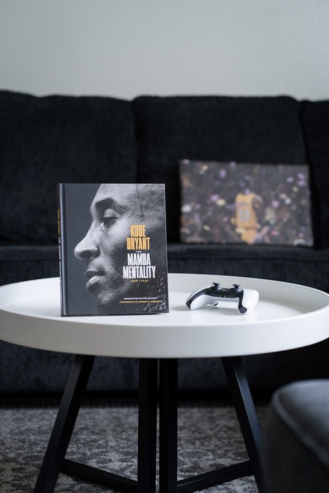 An image of a Mamba Mentality book with Kobe Bryant's face on the cover.