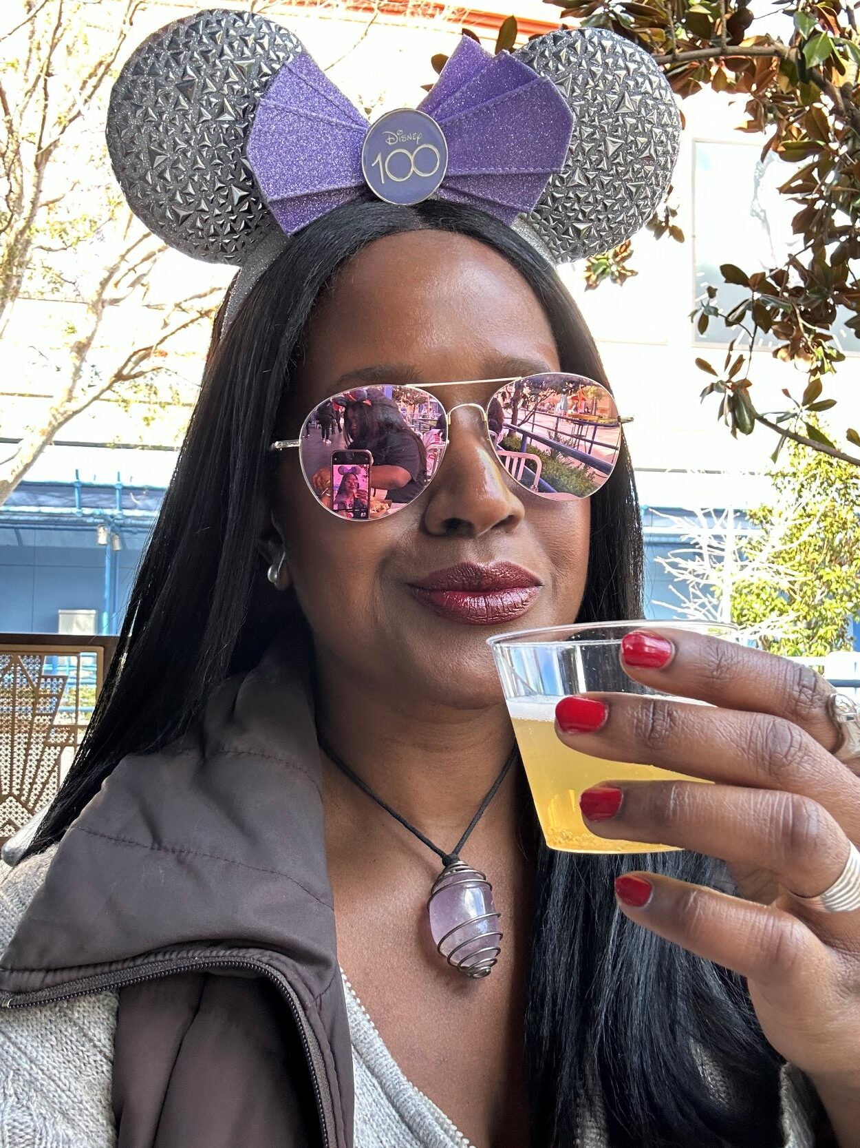 An image of lifestyle blogger Ariel Johns sipping a mimosa as the Disney California Adventure Food & Wine Festival.