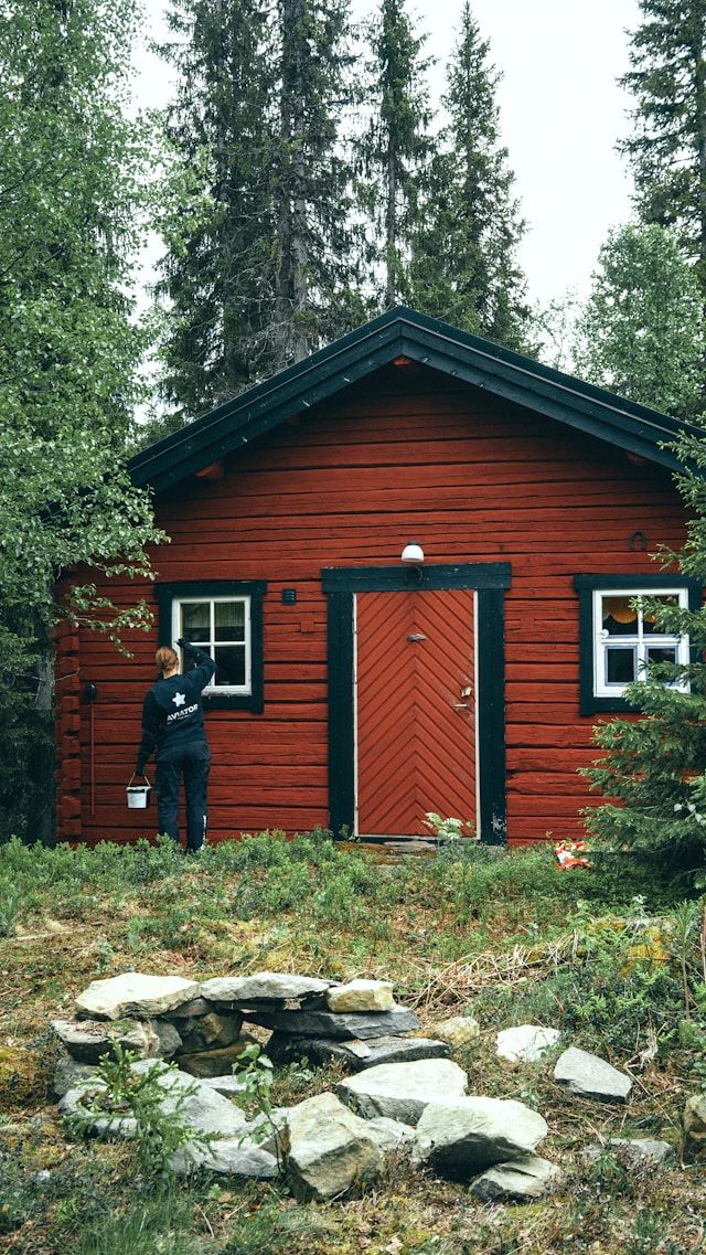 An image of someone painting the exterior of a house.