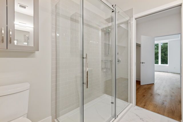 An image of a glass shower with a swinging door.