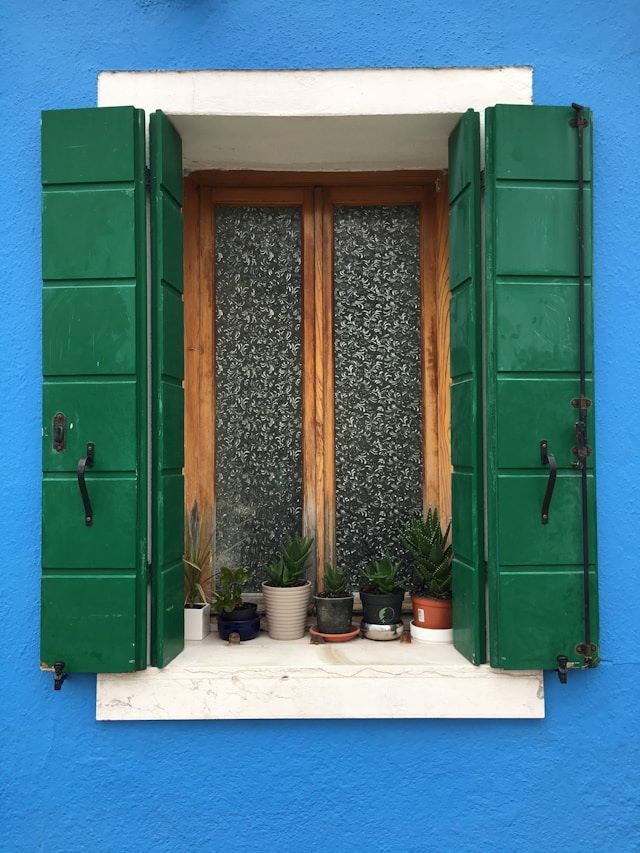 An image of green wooden shutters