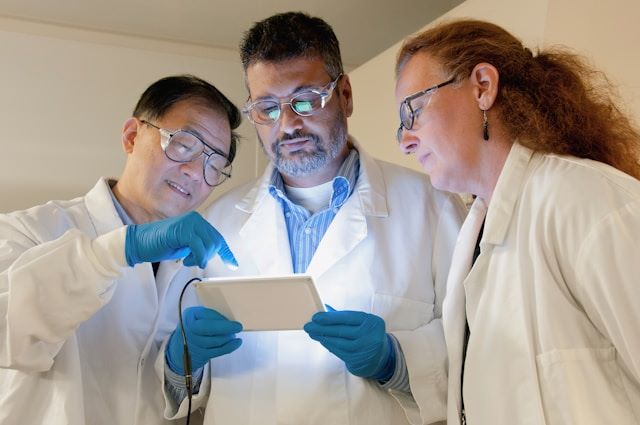 An image of three scientists reviewing the effects the Lookah dab pens from the Dr.Ganja hemp store. 