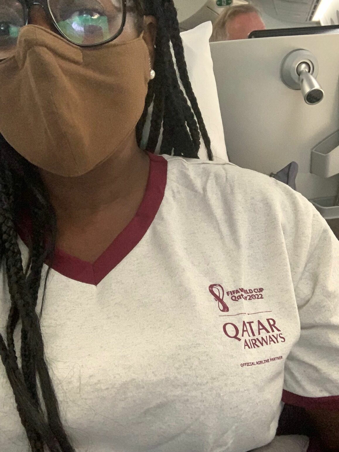 An image of An image of one of my favorite travel hacks. In the image,  lifestyle blogger Ariel Johns in her Qatar pajamas from her Qatar business class flight.