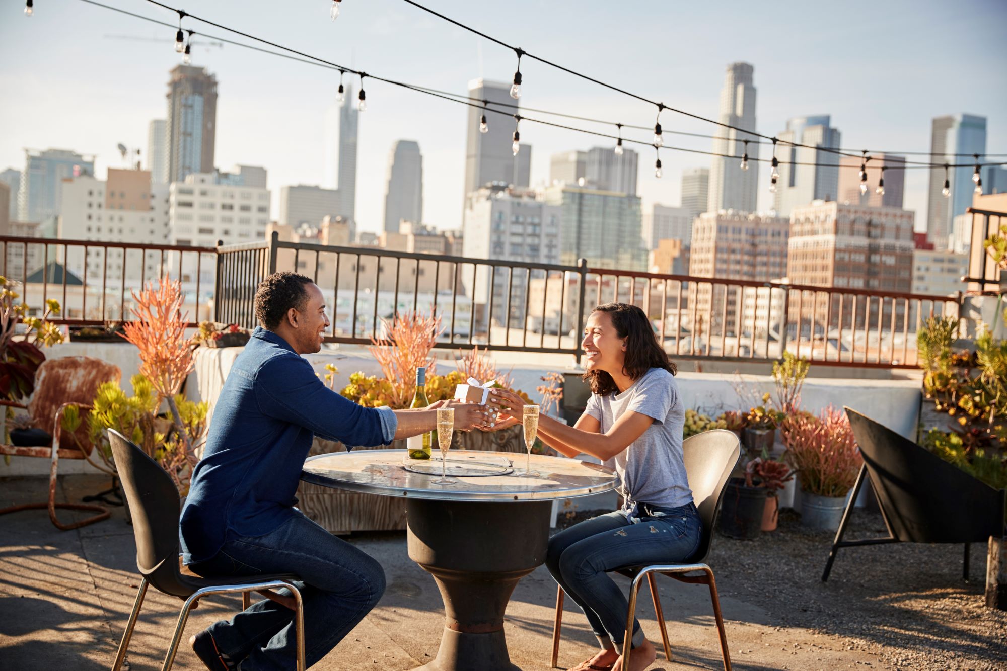 An image of a couple dining at a rooftop restaurant.