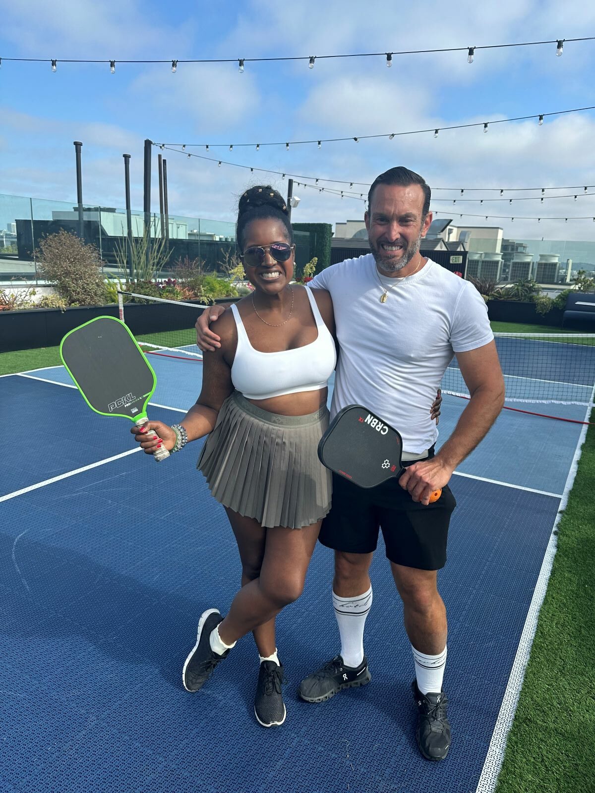 An image of lifestyle blogger Ariel with  Fabio at the pickleball courts near me.