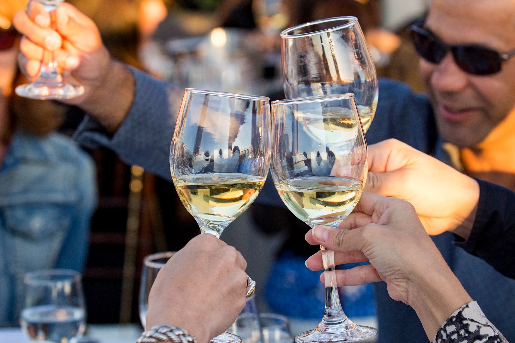 An image of people holding wine glasses at last year's "A Culinary Evening with the California Winemasters" event.