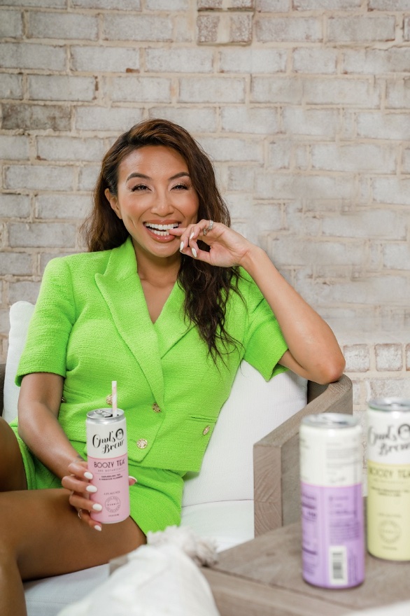 An image of Jeannie Mai with some of the best canned cocktails, the Owl's Brew.